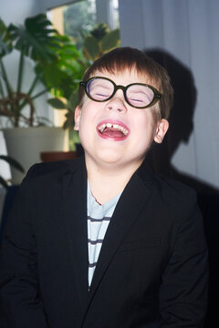 Boy wearing glasses laughs