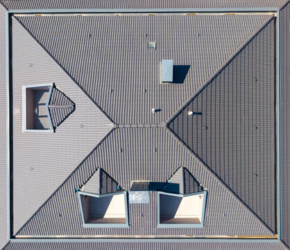 Top Down View Of Anthracite Tiled Roof With Dormer Skylights