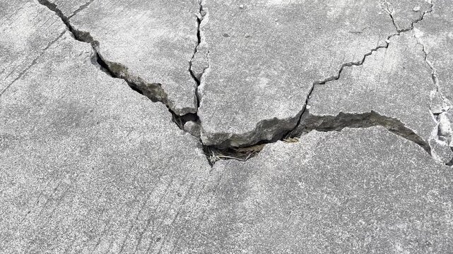 Severe structural failure and deep crack on concrete road