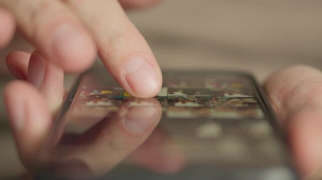 A hand navigates a smartphone screen, highlighting the tactile interaction with digital content. This image represents connectivity, mobile usage, and everyday digital lifestyle