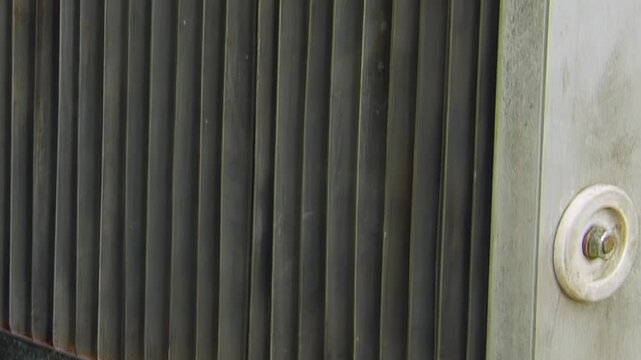 Close View of Repeating Dark Metal Fins and Frame. Close industrial footage emphasizes repeating metal fins, grids, pipes and structural frame details without claiming a specific function.