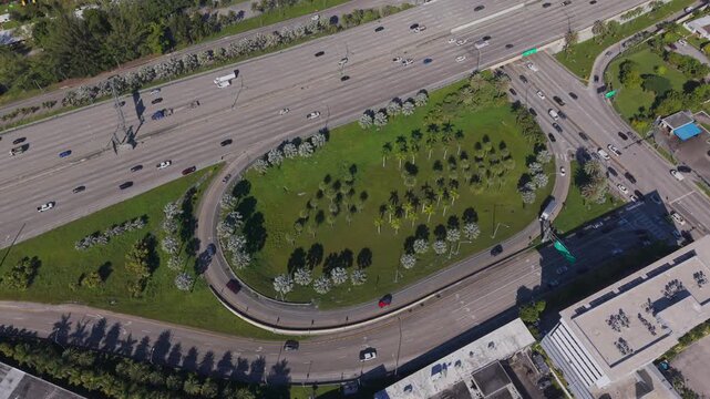 Aerial view of highway cloverleaf interchange with palm trees