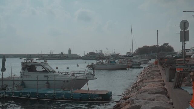 Boats Moored Along Stone Pier at Quiet Harbor in Gijang, Busan, South Korea