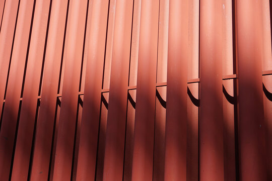 Red painted steel fins with a cross brace in a tight abstract frame