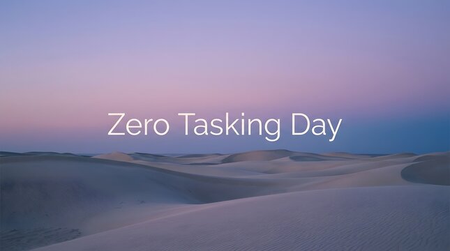 Zero Tasking Day text on desert dunes at golden hour