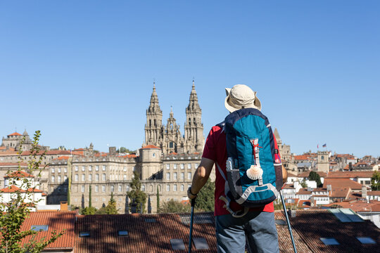 pilgrim contemplating from above in the distance santiago de compostela cathedral after finishing camino de santiago. copy space