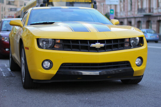 Kyiv, Ukraine - May 26, 2012: Front view of a bright yellow Chevrolet Camaro sport coupe with black stripes