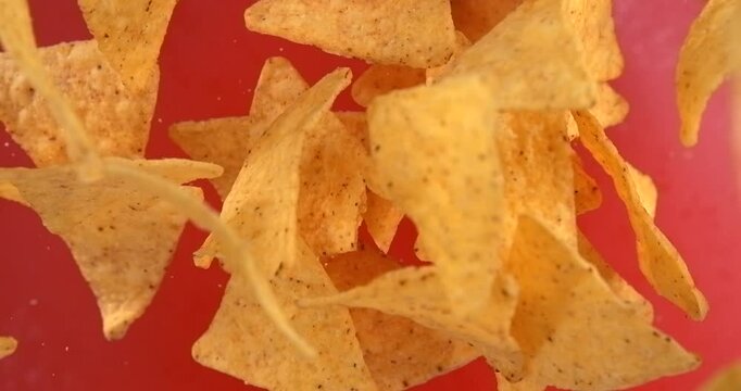 Tortilla chips falling in slow motion 1000 fps on red background