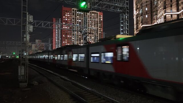 MOSCOW, RUSSIA - October 21.10.2026 Modern passenger train arriving at platform at night