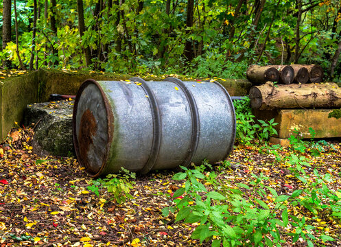 Umweltverschmutzung im Wald, verzinktes altes 200-Liter Metallfass (&Ouml;l- oder Dieselfass) mit umlaufenden Eisenringen zur Verst&auml;rkung, Berlin, Deutschland