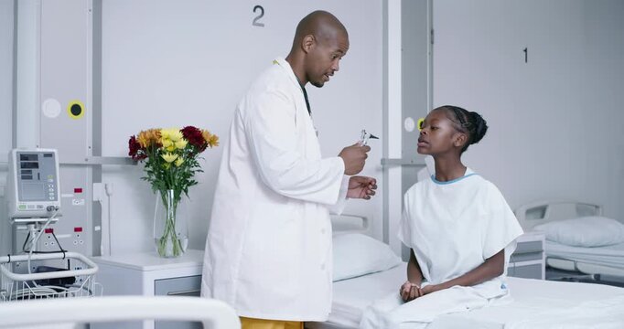 African American Dr entering bay 2 examining teen patient using otoscope, checking ear infection