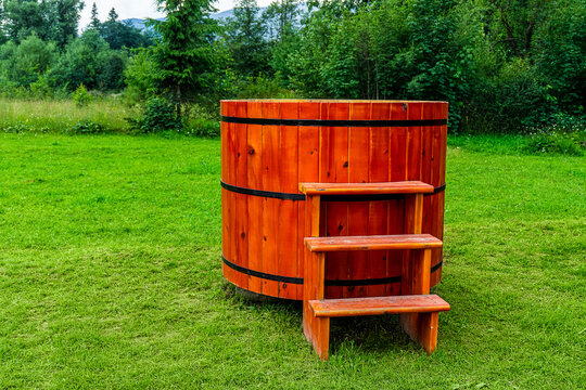 Wooden hot tub on green grass
