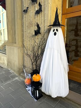 Halloween decorations in the shape of a ghost near the entrance to the house
