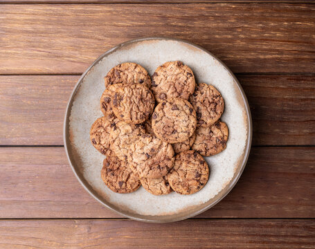 Chocolate chip cookies in a plate over wooden table