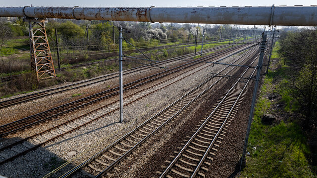 Parallel railway tracks with overhead lines viewed from above