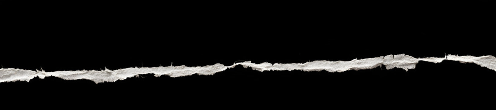 Paper edges with ripped edges visible on a black background