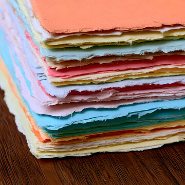 Handmade paper sheets in various colors and with jagged edges are ideal for artistic expression and as background textures for projects and stationery