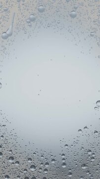Vertical video: Drizzle starting, water droplets merging and sliding into streaks on window glass