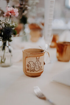 Handmade squirrel mug with pink carnation and thistle