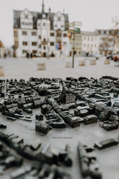 Bronze town model with historic market square behind