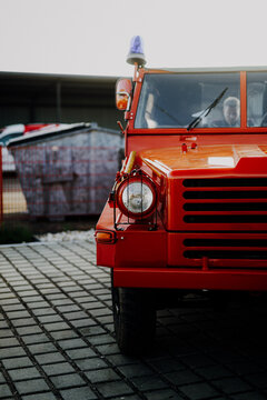 Red vintage fire truck front view with blue beacon