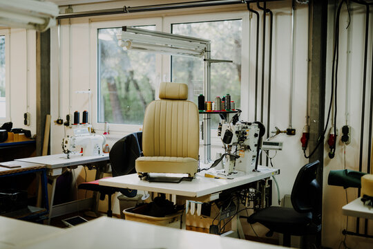 Upholstery workshop with beige car seat and sewing machines