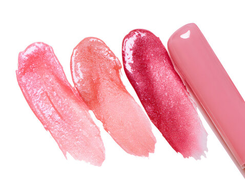 a set including four shimmering lip glosses, a glossy pink nail polish, cosmetics with various textures, a liquid blush, and lipsticks and lip glosses for swatching
