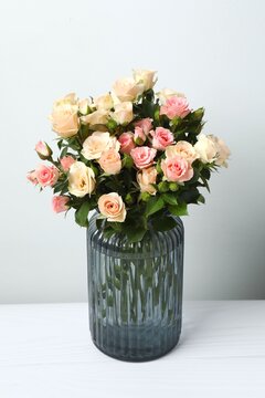 Beautiful bouquet of roses in vase, vertical view