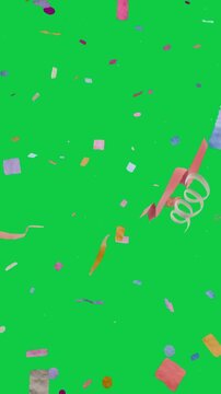 Vertical video: Bursting confetti and ribbons falling curling on transparent backdrop to celebrate