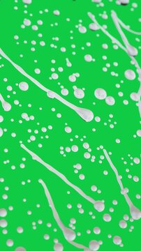 Vertical video: Pouring white drops stretching into streaks, forming dense layers on transparent