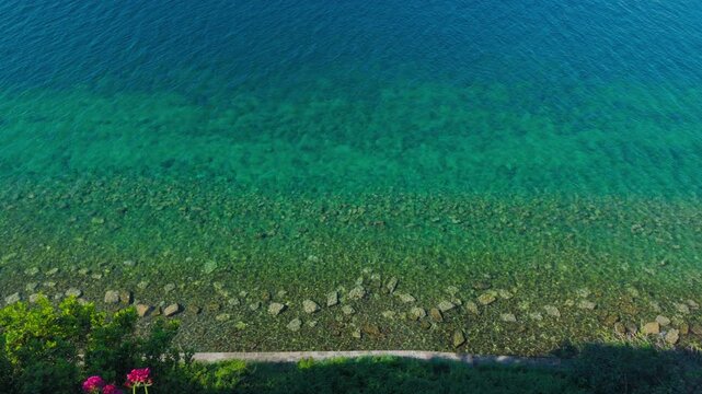High angle static shot of stunning turquoise Adriatic sea and rocky coastline, filmed from Saint George's Parish Church view point in Piran, Slovenia.