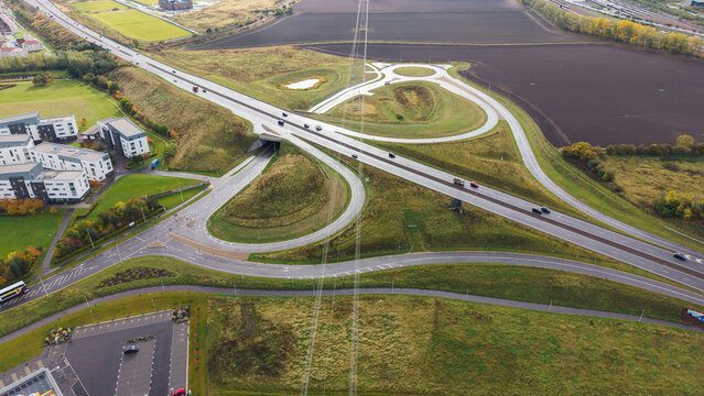 High angle drone view of Queen Margaret junction and slip roads on A1 highway in East Lothian
