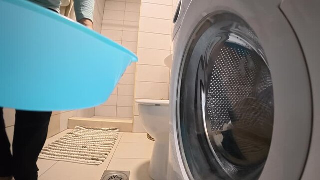 Man Unloading Laundry in Four Views with Blue Basin