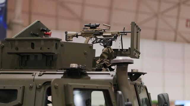 Armored military vehicle turret with machine gun at defense exhibition