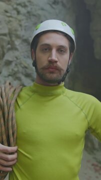 Rock climber maintains focus, Enthusiastic climber in safety gear demonstrates calmness during rocky ascent