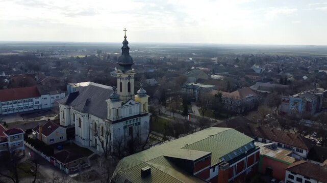 Aerial view of the Catholic church with flying pigeons in Kula, Vojvodina, Serbia. Drone landscape. g.