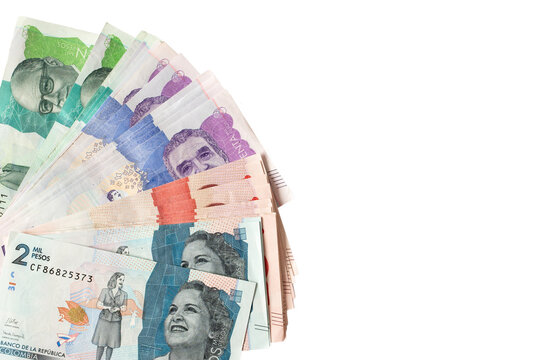 Colombian peso banknotes fanning across a white background
