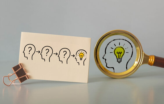 Creative Problem Solving and Idea Discovery Concept with Human Heads and Magnifying Glass.