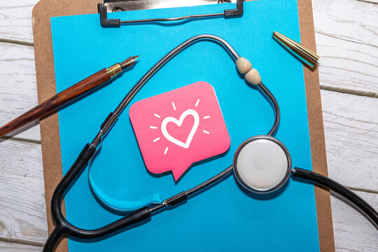Healthcare Communication and Patient Care Concept with Heart Symbol on Pink Speech Bubble and Stethoscope.