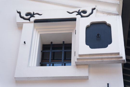 White Plaster Window with Open Decorative Shutter