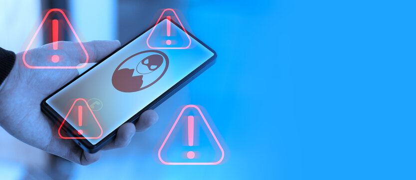 Smartphone displaying danger alerts during a suspicious call and copy space; concepts of digital threats, fraudulent calls, and cybersecurity