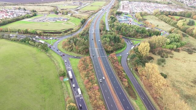 Aerial view of drone performing orbit tracking over roundabout at Old Craighall junction on A720 and A1 road near Edinburgh