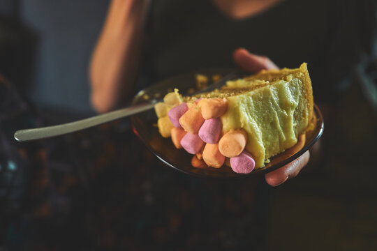 Overhead View of a Marshmallow-Topped Cake Slice on an Amber Plate