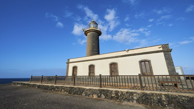 Lighthouse, building, super wide angle, fence, wild south, Punta de Jandia, barren landscape, blue sky, few clouds, Fuerteventura, Canary Islands, Spain