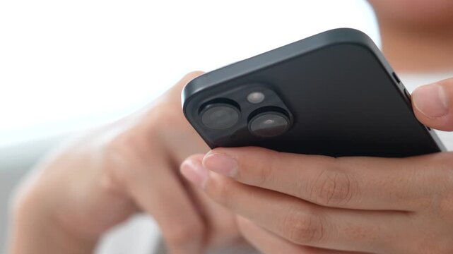 woman holds smart phone in her hands and scrolls through the news feed. Close up of hand uses mobile. point finger on screen, texting text message.