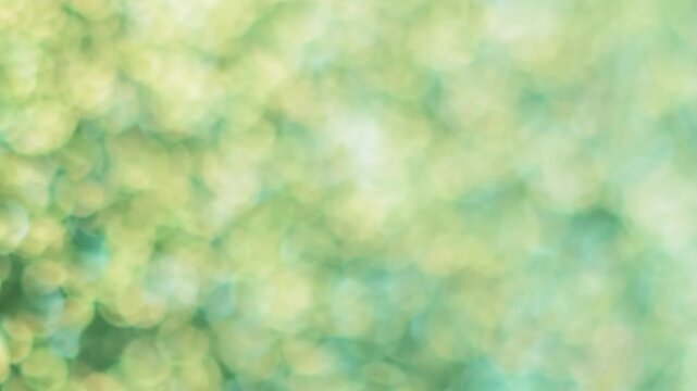 Shiny particles glare. Blur sparkle. Defocused light transition optic lens effect. Green yellow rays illumination abstract bokeh color background.