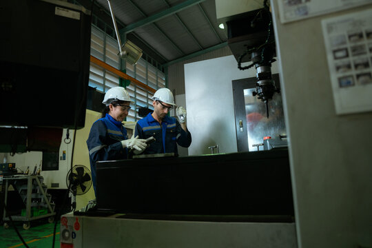 Two Electrical Engineer team working front control panel, Engineer training job with control panel in service room.