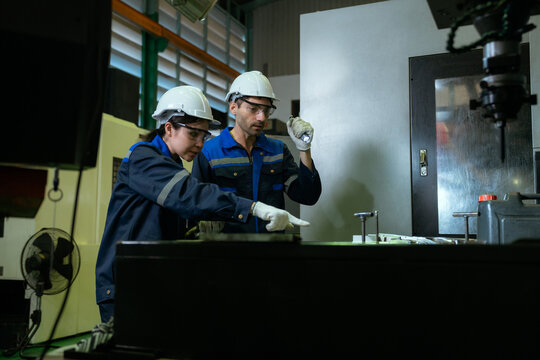 Two Electrical Engineer team working front control panel, Engineer training job with control panel in service room.