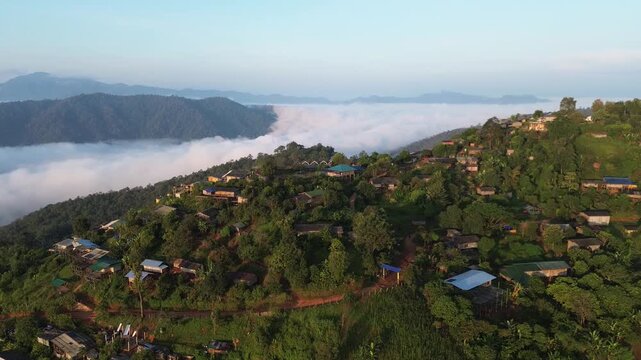 Misty Mountain Forest Ridge Above Cloud Inversion at Sunrise, Lush Woodland Hills, Rural Village Homes, Cultivated Slopes, Winding Path, Blue Sky, Soft Morning Light, Peaceful Scenic Landscape