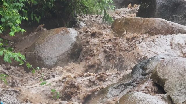 Mountain Stream Flowing Over Granite Boulder Through Tropical Forest, Rainfall Water Cascade, Wet Moss, Muddy Stream, Textured Natural Landscape, Peaceful Water Movement After Rainfall
